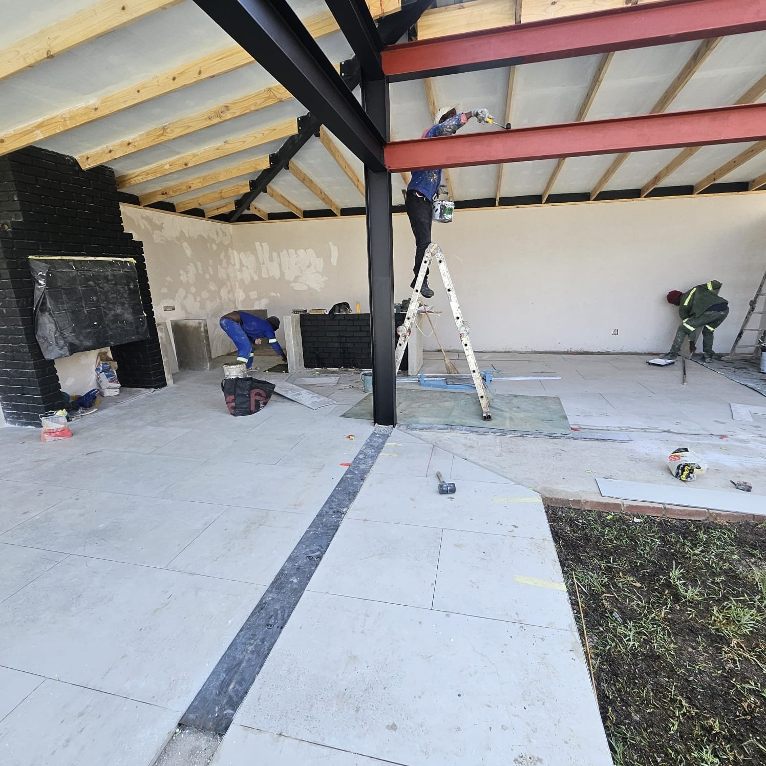 Structural steel column and roof beam with tiling underway, Farrarmere entertainment area