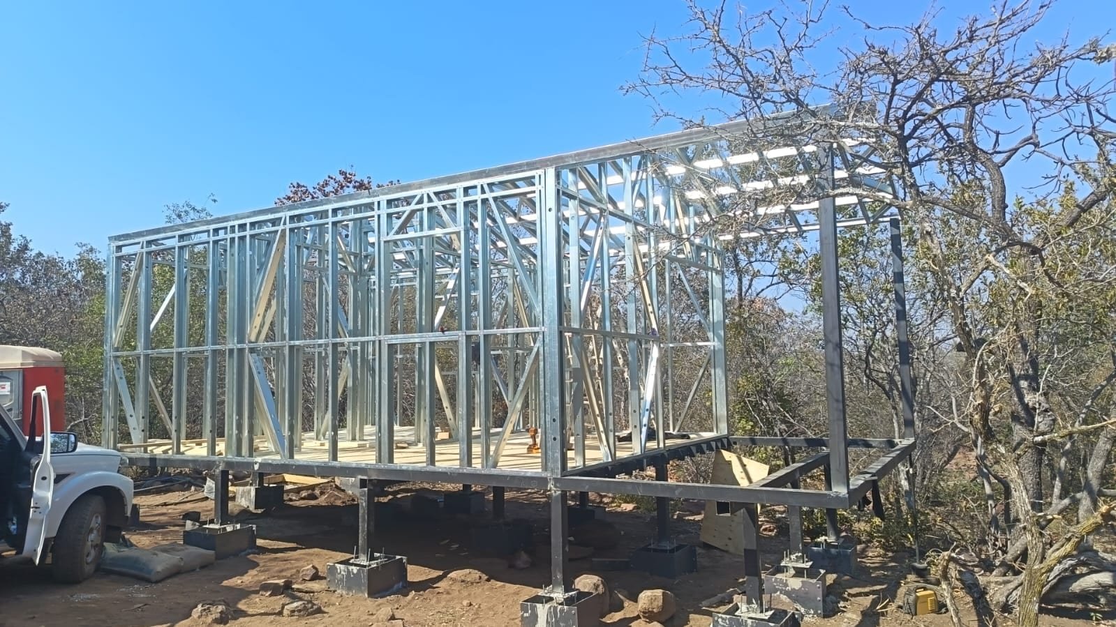 Raised steel frame of a tiny home on stilts, Tamboti River Reserve, South Africa